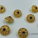 gold button with burgundy crystal
