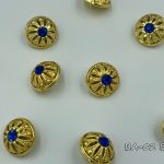 gold button with blue crystal