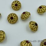 gold button with burgundy crystal