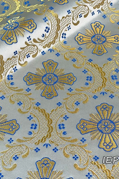 Fabric in white base with gold crosses and blue details and flowers.