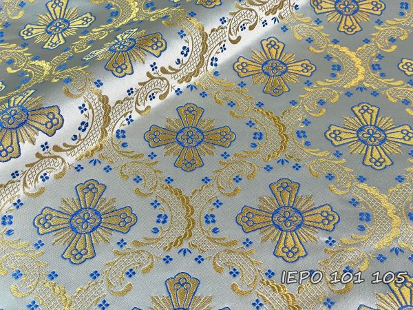Ткань на белой основе с золотыми крестами и голубыми деталями и цветами.
