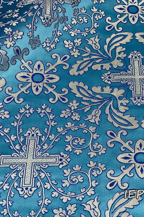 Fabric in light blue base, with crosses, branches and flowers design in silver color with blue details.