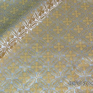 Fabric with a white base, with a design of small gold crosses and branches in repetition.