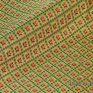 Clerical fabric with a gold base, a design of small green squares forming rhombuses, within which there are red and burgundy flowers.