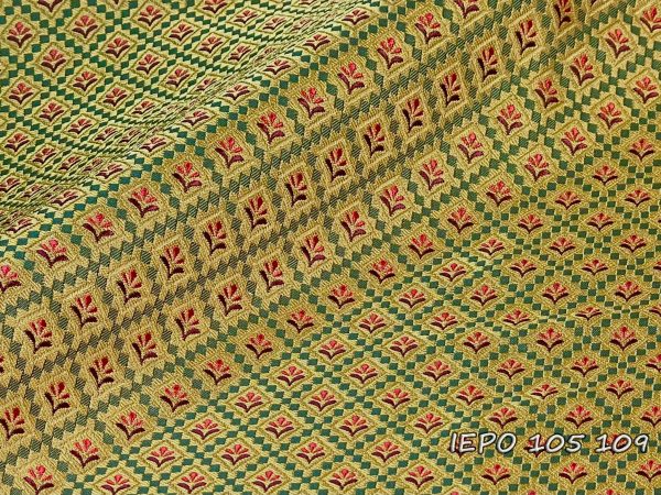 Clerical fabric with a gold base, a design of small green squares forming rhombuses, within which there are red and burgundy flowers.