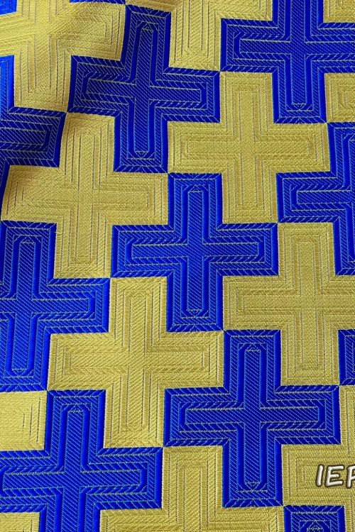 Fabric with a design of continuous square crosses, alternating colors of the crosses in gold and blue.